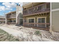 The exterior shows a multi-story condominium building with balconies and stone accents at 3450 S Eagle St # 101, Aurora, CO 80014