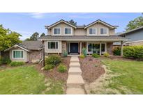 Charming two-story home with a landscaped front yard and a welcoming entrance at 5991 S Eudora Way, Centennial, CO 80121