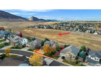 Stunning aerial view of a home backing up to Trailmark Open Space with mountain views at 9665 W Danzig Pl, Littleton, CO 80127