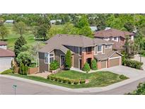 Beautiful two-story home featuring a well-maintained lawn and a picturesque location near a golf course at 8922 S Tuscany Ln, Highlands Ranch, CO 80130