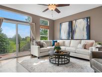 Bright living room with large windows, patio access and comfortable furnishings at 8922 S Tuscany Ln, Highlands Ranch, CO 80130