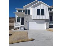 Charming two-story home with white siding, stone accents, and a spacious two-car garage in a desirable location at 1785 Grayside Cir, Castle Rock, CO 80109