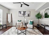 Cozy living room features stylish decor, comfortable seating, and a modern ceiling fan at 2113 Coronado Pkwy # B, Denver, CO 80229