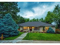 Charming single-story brick home with a beautifully landscaped front yard and inviting walkway to the front door at 10601 E Crestline Ave, Englewood, CO 80111