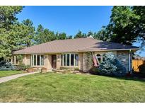 Charming one-story home with mature trees, brick exterior, and well-maintained lawn at 10601 E Crestline Ave, Englewood, CO 80111