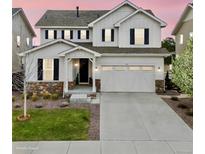 Charming two-story home with white siding, dark shutters, stone accents, and well-maintained landscaping at 7756 S Eaton Park Ct, Aurora, CO 80016