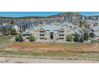 Exterior of condominiums with multiple levels, balconies, and landscaping on a sunny day at 6017 Castlegate Dr # F15, Castle Rock, CO 80108
