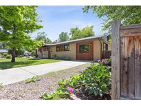 Charming home exterior with well-maintained lawn, landscaping, and a driveway at 2901 Lorraine Ct, Boulder, CO 80304