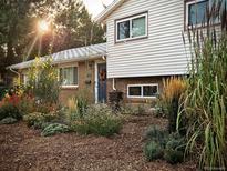 Charming home with a beautifully landscaped front yard featuring diverse plants and a welcoming entrance at 962 S Potomac Way, Aurora, CO 80012