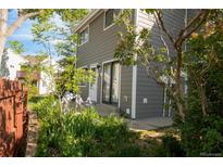 Charming gray two-story with well maintained lawn and garden and inviting patio area, near the entry door at 3740 Iris Ave # B, Boulder, CO 80301
