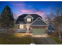 Two-story house with stone and siding exterior, solar panels, and a landscaped yard at 1833 W 131St Dr, Westminster, CO 80234
