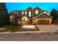 Charming two-story home with a well-maintained lawn and attached two car garage in a suburban neighborhood at 2792 Greatwood Way, Highlands Ranch, CO 80126