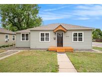 Charming home with a fresh exterior, inviting entrance, complemented by lush green lawn at 5100 Clay St, Denver, CO 80221
