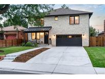 Beautiful two-story home boasting a stone facade, covered porch, and attached two-car garage at 1157 Jersey St, Denver, CO 80220