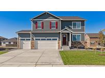 Charming two-story home featuring a three-car garage and well-manicured lawn at 1884 Westport Ave, Berthoud, CO 80513