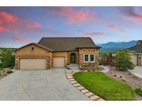 Charming single-Gathering home featuring a well-manicured lawn, three-car garage, and stunning mountain views at 15506 Short Line Ct, Monument, CO 80132