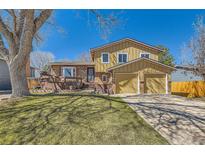 Inviting two-story home with a well-maintained lawn and a charming front deck at 4593 S Field St, Littleton, CO 80123