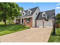 Charming two-story brick home with a well-manicured lawn and attached three-car garage at 6839 S Niagara Ct, Centennial, CO 80112