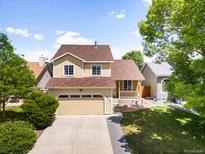 Charming two-story home featuring a well-maintained front yard and a two-car garage, perfect for Gathering living at 6318 Newton Ct, Arvada, CO 80003