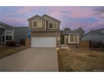 Charming two-story home featuring a two-car garage and inviting curb appeal with manicured landscaping at 4485 E Andover Ave, Castle Rock, CO 80104