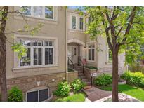 Charming facade with classic architectural details, brick accents, and lush green landscaping at 335 Josephine St # D, Denver, CO 80206