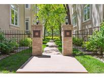 Beautiful walkway with brick pillars leads to lush landscaping and well-maintained buildings, enhancing the property's appeal at 335 Josephine St # D, Denver, CO 80206