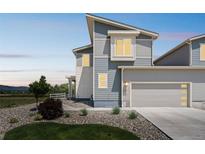 Inviting two-story home with a stone accent and manicured landscaping enhances curb appeal at 1842 Peak Prairie Ln, Monument, CO 80132