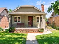 Charming bungalow-style home featuring a cozy front porch with swing and a well-maintained lawn at 4250 Wyandot St, Denver, CO 80211