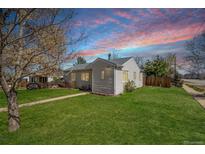 Charming single-story home with a well-manicured front lawn, sidewalk and landscaping at 3492 S Elm St, Denver, CO 80222