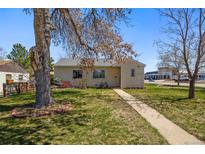 Charming single-story home featuring a well-maintained lawn and mature trees in a suburban setting at 3492 S Elm St, Denver, CO 80222