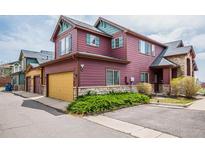 Two-story home with a two car garage, stone accents, and colorful facade at 2552 W 82Nd Ln # C, Westminster, CO 80031