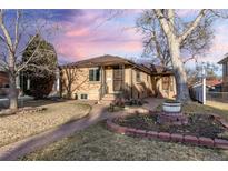 Charming brick home featuring a well-manicured front yard and inviting entrance at 2434 S Ogden St # 2434-2436, Denver, CO 80210