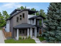 Modern two-story home boasts mixed material facade, covered entry, and manicured landscaping at 2540 Xavier St, Denver, CO 80212
