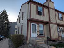 Inviting two-story townhouse with neutral siding, complemented by brown trim and a well-maintained front yard at 14465 E Hawaii Cir # A, Aurora, CO 80012