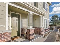 Inviting front porch and walkway leading to the entrance of this charming townhome at 16058 E Geddes Ln # 26, Aurora, CO 80016
