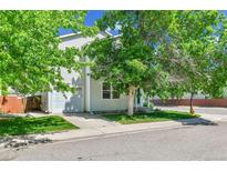 Charming two-story home with attached garage, mature trees, and a well-maintained front yard at 11803 W Tufts Pl, Morrison, CO 80465