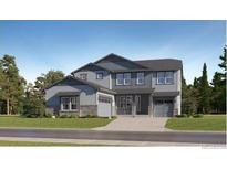 New construction home with two-car garage and stone accents on a well maintained lawn at 661 Sunrise St, Erie, CO 80516