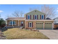 Inviting two-story home with brick accents, dual garage, and well-maintained landscaping at 10157 W Fremont Pl, Littleton, CO 80127