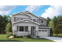 Charming two-story home with a welcoming front porch, a two-car garage, and classic architectural details at 2633 Sawyer Ln, Erie, CO 80026