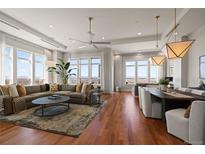 Bright open living space with hardwood floors and expansive windows showcasing city views at 5455 Landmark Pl # 1106, Greenwood Village, CO 80111