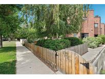 Charming front yard with a wooden fence and a gate, offering a welcoming entrance to the home at 1753 Race St, Denver, CO 80206