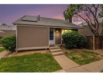 Charming home featuring a well-maintained front yard and a welcoming entrance with steps leading to the front door at 3852 S Genoa Ct # B, Aurora, CO 80013