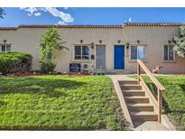 Charming home featuring a lush green lawn, landscaped garden, and inviting front entrance with a bright blue door at 3081 W 18Th Ave, Denver, CO 80204