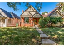 Charming brick home with manicured lawn and inviting walkway, creating an appealing curb appeal at 55 S Grant St, Denver, CO 80209