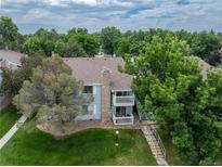 Inviting two-story condo with dual balconies, stone chimney and lush green landscape at 13404 E Jewell Ave # 101, Aurora, CO 80012