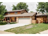 Charming two-story home with a large front yard, an attached two-car garage and cedar shake siding at 365 Seminole Dr, Boulder, CO 80303