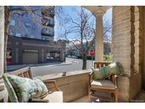 Inviting front porch with seating area perfect for enjoying the neighborhood views at 1301 N Ogden St # 1A, Denver, CO 80218
