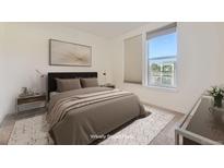 Staged bedroom with large window, blinds, stylish decor, and neutral colors at 1313 S Clarkson St # 205, Denver, CO 80210
