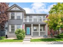 Charming two-story home with a welcoming front porch and a second story balcony at 186 S 45Th Ave, Brighton, CO 80601