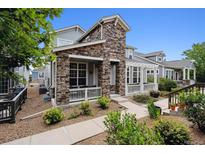 Charming two-story home with stone accents and a landscaped front yard at 5723 S Union Ct, Littleton, CO 80127